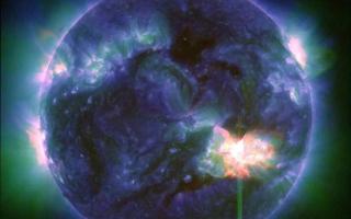 A solar flare, as seen in the bright flash in the lower right, captured by Nasa’s Solar Dynamics Observatory on May 9 (Nasa/SDO via AP)