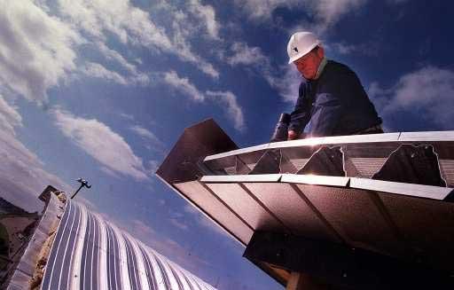 23/03/1999: Roofing contractors finish off the aluminium sheeted roof on the IMAX complex. Picture: Richard Crease.