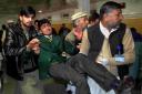 AFTERMATH: A student is rushed to safety from the Peshawar school