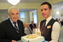 Former Bournemouth Rotary president John Bowen is presented with a Rotary cake to mark his 103rd birthday