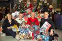 FESTIVE GIFTS: From left, Lorna Trent of BCHA, Flirt Cafe owners Rob Hazell and Peter Moody and Tom Payne from BCHA