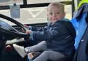 Leo, 21 months old, in the front seat of the Morebus vehicle