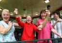 HIGH SPIRITS: Southbourne residents join in ‘All the Bells’ at the Fisherman’s Walk bandstand to mark the first day of the Olympic Games