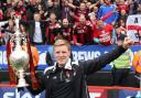 WINNER: Eddie Howe with the Championship trophy