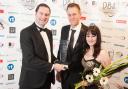 WINNERS: L-r, Greg Ford of Advanced Exchequer presents a Dorset Business Award to Jonathan Davies and Hayley Evans of the Training Room in 2014