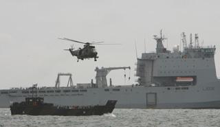 Launch event at Bournemouth Pier - Sea King and landing craft in front of RFA Largs bay