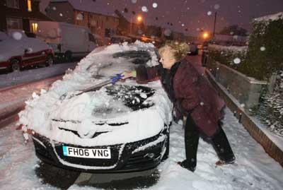 Valentina Barton clearing snow from her car in West Howe. Picture by Richard Crease.