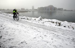 A cyclist riding around Holes Bay in Poole. 