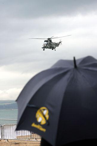 The first day of Bournemouth Air Festival sees torrential rainfall, yet the Sea King helicopter makes an appearance at Bournemouth beach.
