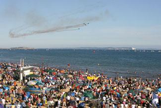 Saturday Flying display. The Blades perform  in front of a packed beach.