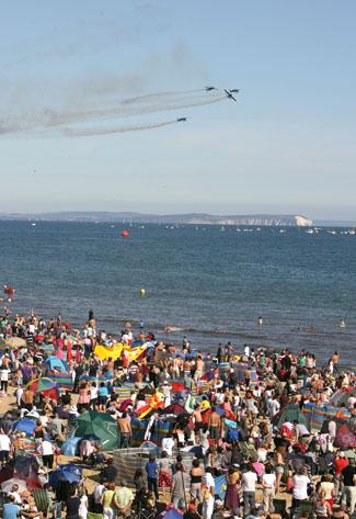 Saturday Flying display. The Blades perform  in front of a packed beach.