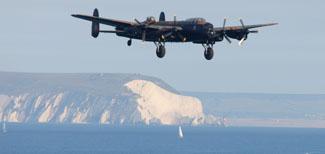 Saturday Flying display. Lancaster from the Battle of Britain memorial flight makes an approach from  the Solent.