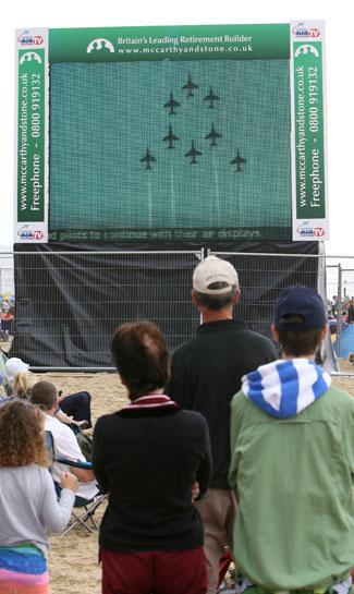 Pictures from the final day of the Bournemouth Air Festival 2011. Festival goers pay a  silent tribute to Red Arrows pilot Jon Egging.  