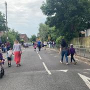 Parents and children in the temporarily closed road outside the entrance to St Clements & St Johns School, Boscombe, at school drop-off time
