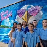 Children with the new Tech Moon mural at Stourfield Infant and Junior Schools.