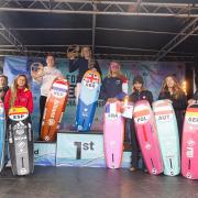 Ellie Aldridge (centre) stands atop the podium after being crowned European kitefoil champion