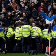 Police officers attempt to contain trouble between rival fans during West Brom’s FA Cup fourth round tie against Wolves (Bradley Collyer/PA).