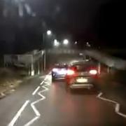 Moment car dangerously overtakes traffic