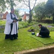 Robert Forbes's ashes being put in the garden