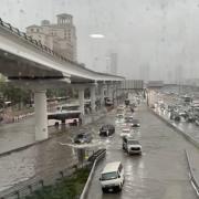 Cars driving through flood water in Dubai.