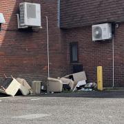 Sue Ryder has asked people not to leave items behind the store as fly tip builds.