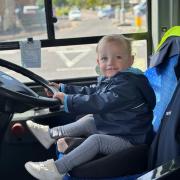 Leo, 21 months old, in the front seat of the Morebus vehicle