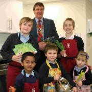 COOKS OF THE FUTURE: Dr David Rogers, president of the Rotary Club of Christchurch, with some children eager to take part in the classes