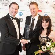 WINNERS: L-r, Greg Ford of Advanced Exchequer presents a Dorset Business Award to Jonathan Davies and Hayley Evans of the Training Room in 2014