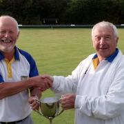 VICTORY: Mick McGing, Iford Bridge's president, presents the Christchurch Times Cup to Highcliffe captain Andy Phillips