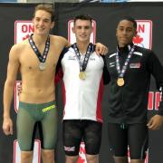 GOLD RUSH: Jacob Peters, centre, came away from the Swim Ontario Junior International with four wins