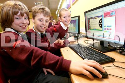 Branksome Heath Middle School,  L-R are Josh Pengelly,10, Brandon Northover,9, and Keisha Holden,9, working in the IT suite.