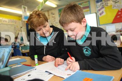 Hillbourne School and Nursery in Poole, 21.2.12. Year six  Teacher Fiona McLaren   working with  Scott Morris  in a literacy class.
