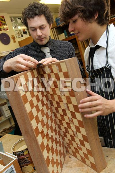 Year 11 Resistant Materials teacher Andrew Morris, left, works with pupil Connor Perring.