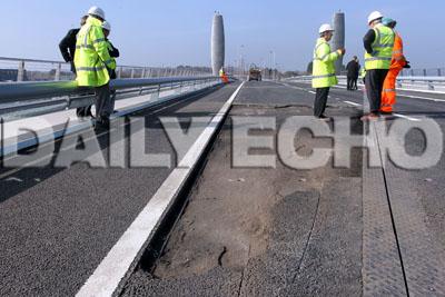 The Twin Sails bridge undergoes repair work to a section of tarmac. The hole can be seen in the forground leaf of the bridge.