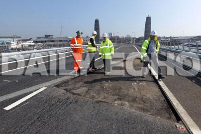The Twin Sails bridge undergoes repair work to a section of tarmac. The hole can be seen in the forground leaf of the bridge.