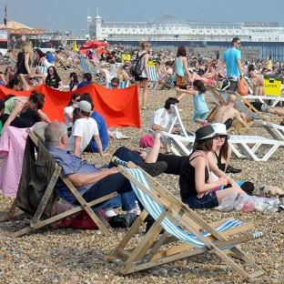 Bournemouth Echo: People enjoy the warm weather on Brighton beach