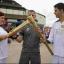 n The torch being passed on to Ryan Proudley by Mariam Kazem-Malaki