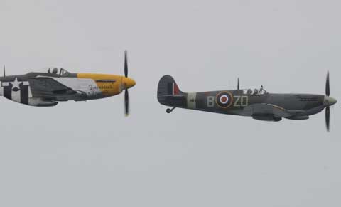 The P-51 Mustang and Spitfire during the historic re-enactment at the 2012 Bournemouth Air Festival. Picture by Corin Messer.