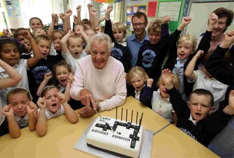 BIRTHDAY: Staff and pupils of Mudeford Infants School celebrate the 80th birthday of Jack Kynaston