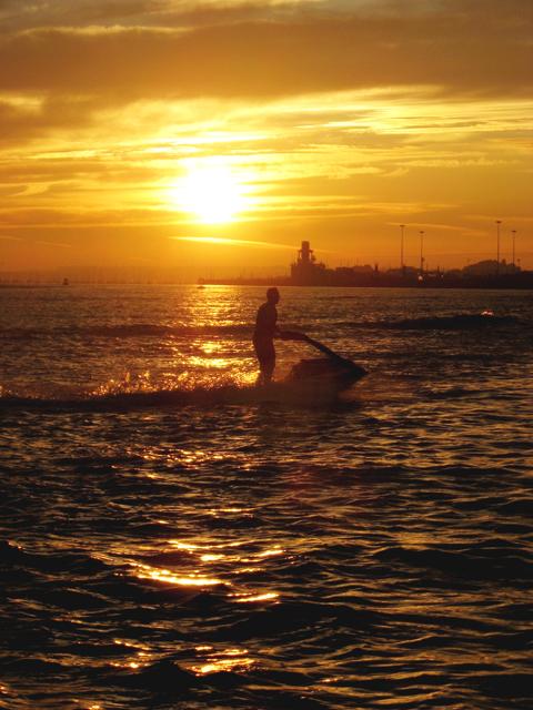 A jetski rider in the sunset at Poole Harbour. 