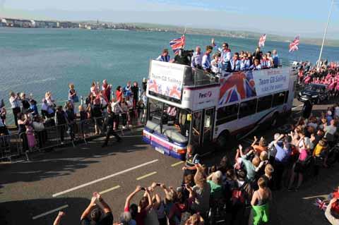 Team GB sailors parade along Weymouth Esplanade in an open top bus