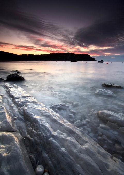 Lulworth Cove at sunrise and at low tide. Taken by Rob Rowe.