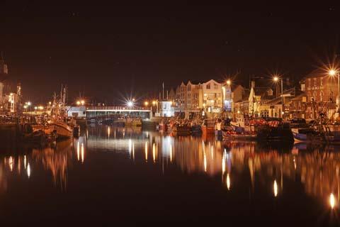 Weymouth Town Bridge in the early hours of an April morning with a few stars peeking through in the nights sky, by Andy Harris 