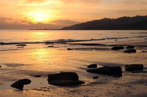 Charmouth beach looking towards Lyme Regis at sunset by Graham Hunt