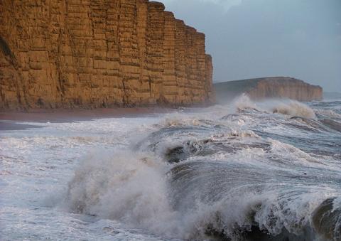 A very stormy West Bay with the waves battering against East Cliff, by Marie Mears

