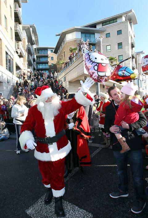 People flock to Poole Quay to see the arrival of Santa by RNLI lifeboat, then watch the Christmas procession down the high street to the Dolphin Centre.