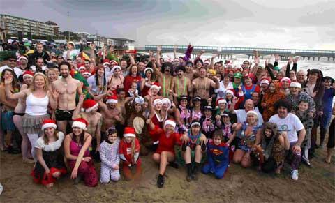 FUNDRAISING FUN: Above, people pose for a picture on Boscombe beach.