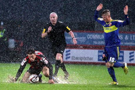 RAIN, RAIN AND MORE RAIN: Harry Arter goes for an early bath during the second half on Saturday