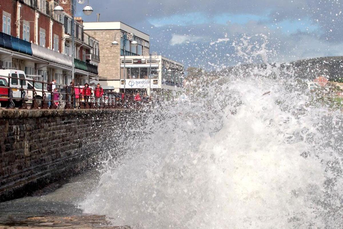 See all Daily Echo and reader pictures of damage left behind after St Jude hits Dorset. Waves crashing in Swanage.