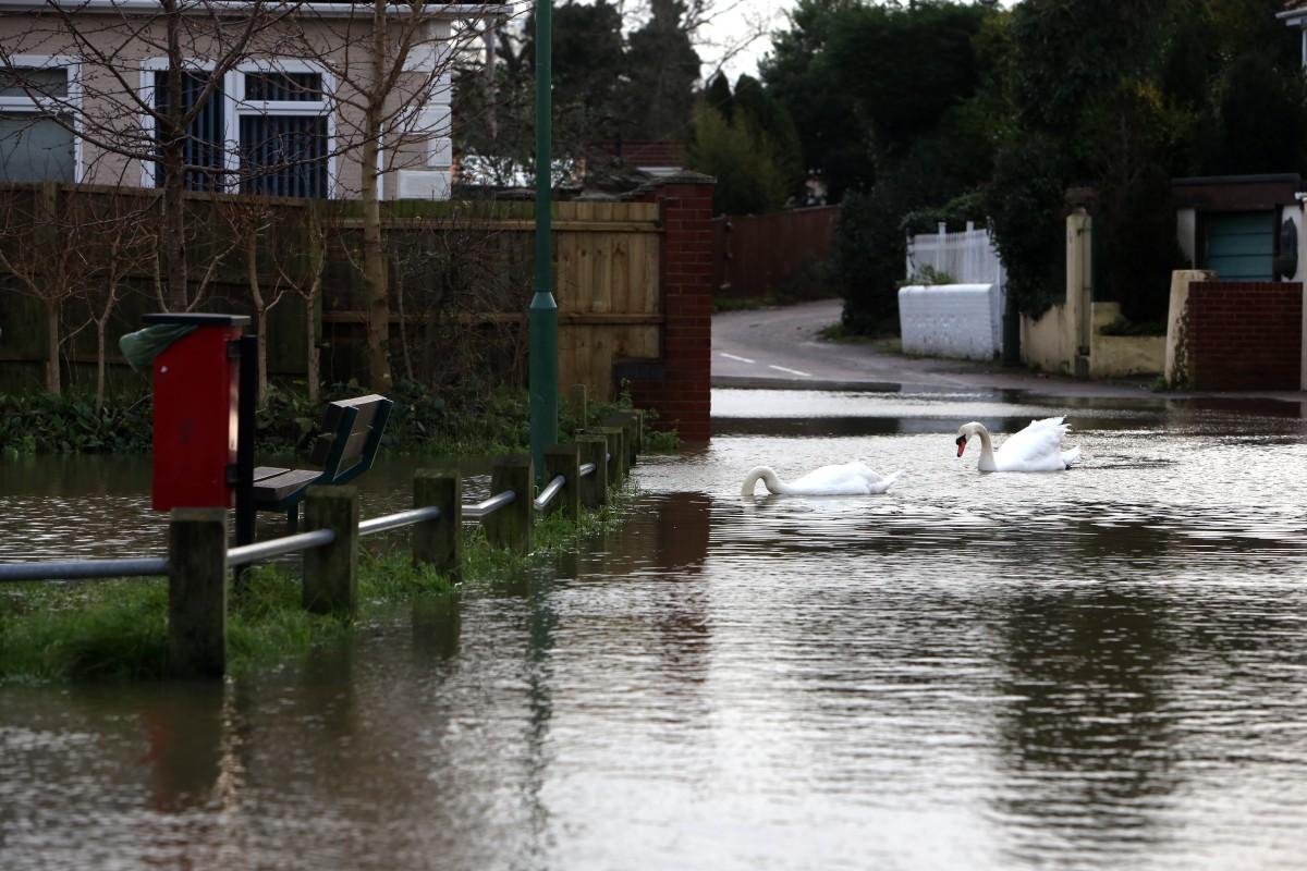 Heavy rain and strong winds cause flooding and high tides across Dorset.  Flooding at Iford.